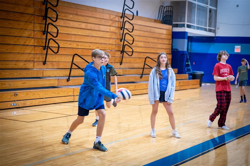 Students play volleyball in PE